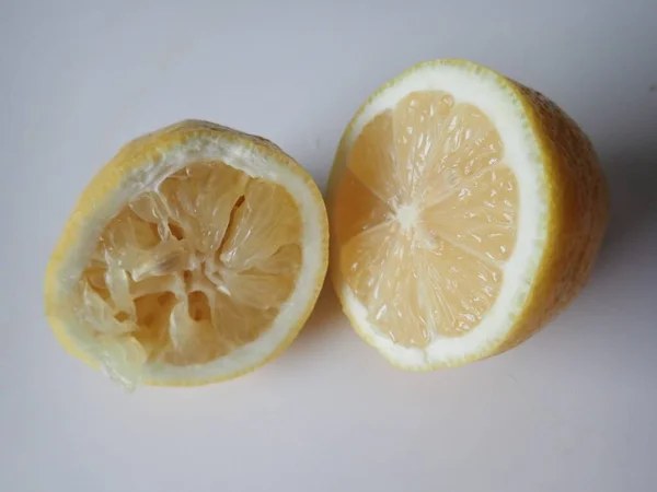one lemon cut into halves on a table
