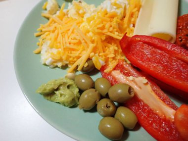 portion of scrambled eggs with vegetables on a table