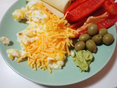 portion of scrambled eggs with vegetables on a table