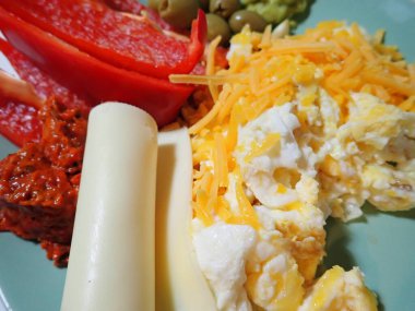 portion of scrambled eggs with vegetables on a table