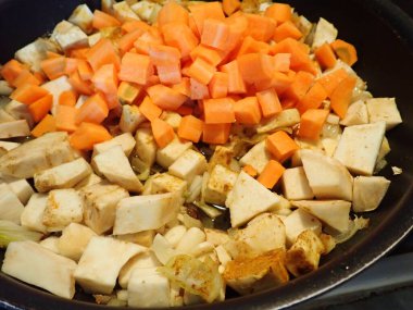 cooking a fresh homemade vegetable curry  in kitchen