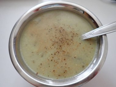 bowl of a green broccoli soup served
