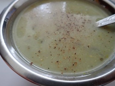 bowl of a green broccoli soup served