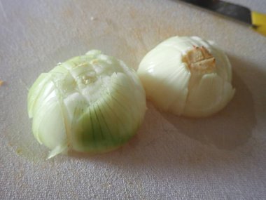chopped onion on a cutting board in kitchen