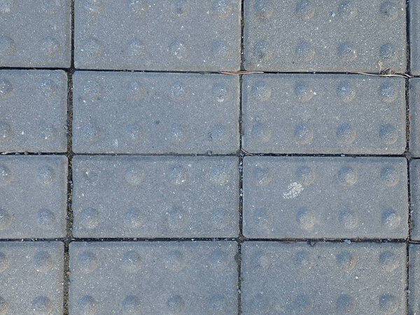 Detail of a street concrete cobble tiles pattern