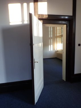 Parlak güneş eski bir binanın camına vuruyor.