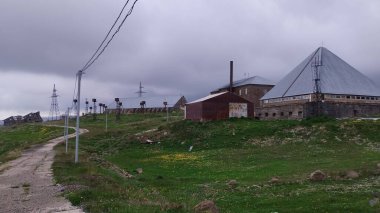 old abandoned meteorogical station in armenia mountains by kari lich lake clipart