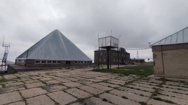 old abandoned meteorogical station in armenia mountains by kari lich lake clipart