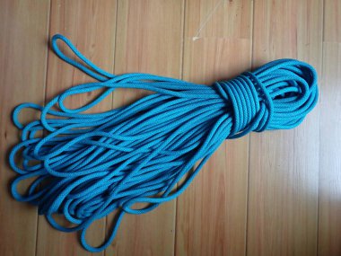 folded blue rope for sport rock climbing clipart