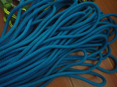 folded blue rope for sport rock climbing clipart