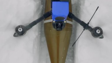 FPV drone stands in the snow, close-up. View from above. prepare for takeoff.