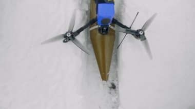 FPV drone stands in the snow, close-up. View from above.