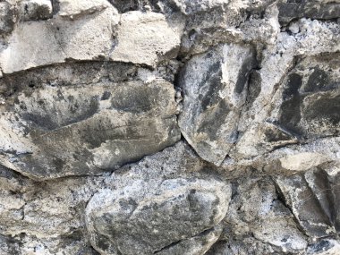 Taş duvar desenli fotografın arka planı. Kırık bir taştan bir duvar parçası. Gerçek fotoğraf..