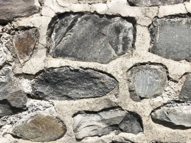 Taş duvar desenli fotografın arka planı. Kırık bir taştan bir duvar parçası. Gerçek fotoğraf..