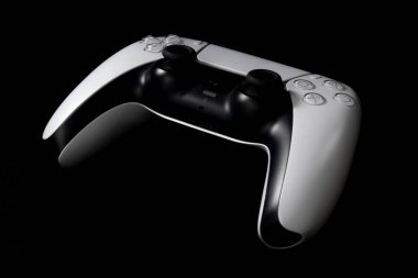 Black and white gamepad (controller) on a black background