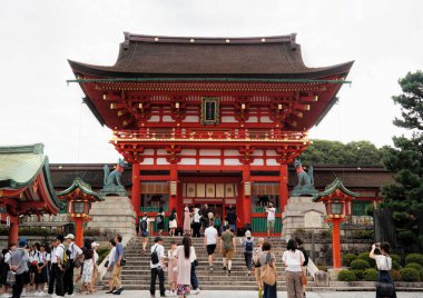Kyoto, Japan - Sept, 2017: The Tori gates at Fushimi Inari Shrine with red wooden Asian architecture