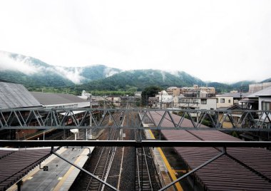 Kyoto, Japan - Sept, 2017: Arashiyama train railway through bamboo forest and mountains