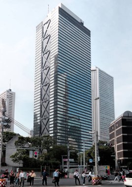 Tokyo, Japan - Sept, 2017: View of looking up tall modern buildings and sky in day time. Famous business district in Tokyo, where many company office buildings are located