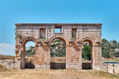 Antalya, Turkey - July 12, 2023: Ancient ruins of city gate which known Arch of Modestus in ancient Lycian city Patara