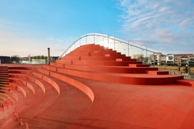 Netherlands, Amsterdam - April 10, 2024: The clubhouse of Tennis IJburg designed by MVRDV. Stepped bleacher style seating on the roof clipart
