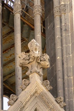 Close-up of intricate Gothic stone carvings on a historic building, showcasing detailed craftsmanship and architectural design elements often seen in cathedrals and ancient structures. clipart