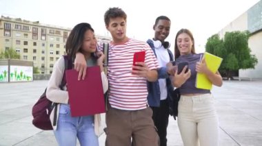 Bir grup öğrenci birlikte selfie çekiyor ve üniversitede birlikte gülüyorlar. Teknoloji ya da ağ kurma, bağlantı ve mutlu üniversiteliler sosyal medya için gülümserken fotoğraf çekiyorlar.