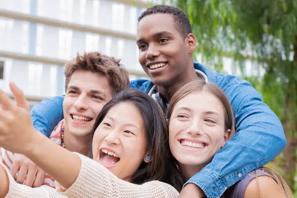 group of friends taking a selfie together and laughing together at the university.Technology or networking, connectivity and happy college people take a photo smiling for social media