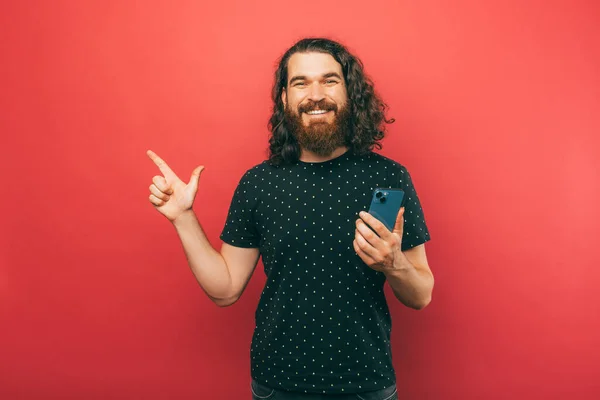 Good Deal Young Bearded Hipster Man Long Hair Pointing Copyspace — Stock Photo, Image