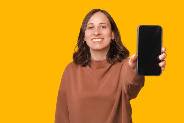 Joyful Jonge Student Vrouw Tonen Mobiele Telefoon Gele Achtergrond — Stockfoto