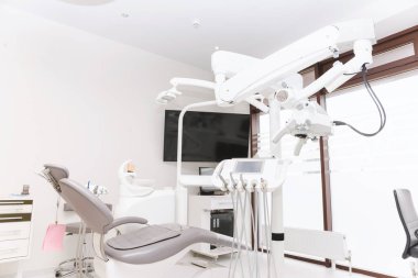 Photo of modern dental equipment in stomatology orthodontic center. clipart