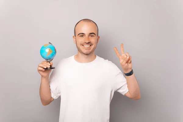 Jeune Homme Paisible Tient Petit Globe Terrestre Montre Geste Paix — Photo