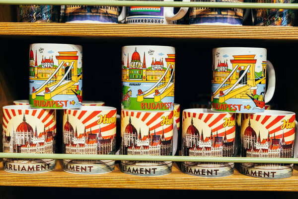 Венгрия, Будапешт, 17 июня 2022. Букет сувенирных чайных кружек с мадьярскими достопримечательностями на рубашке с рынка в Будапеште.