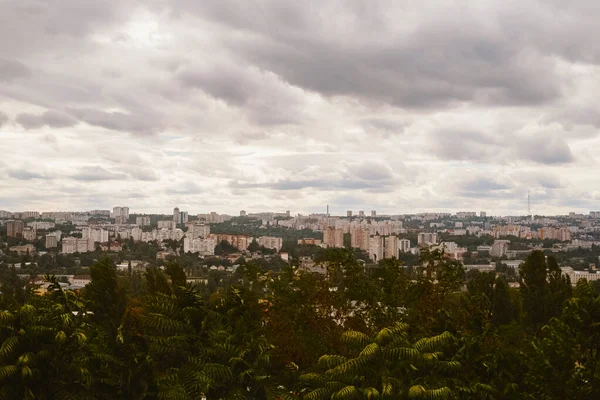 Nice cityscape of an european city with green trees on a cloudy and windy summer day.