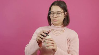 Footage of young woman enjoying and smelling good tasty coffee.
