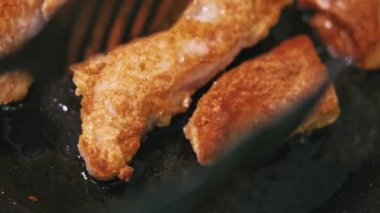 Close up footage of preparing chicken meat in frying pan.