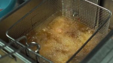 Close up footage of Chef preparing frying chicken.