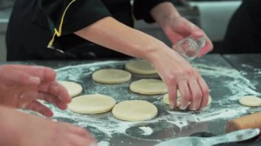Close up footage of chef preparing dough for donuts.