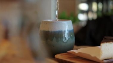 Close up video of pouring tea in cup in restaurant.