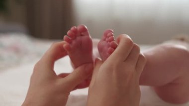 Close up video of Mother making massage to baby foot.