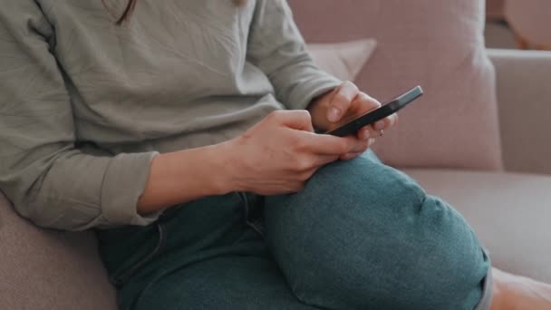 Footage Young Woman Sitting Sofa Typing Smartphone — Stock Video