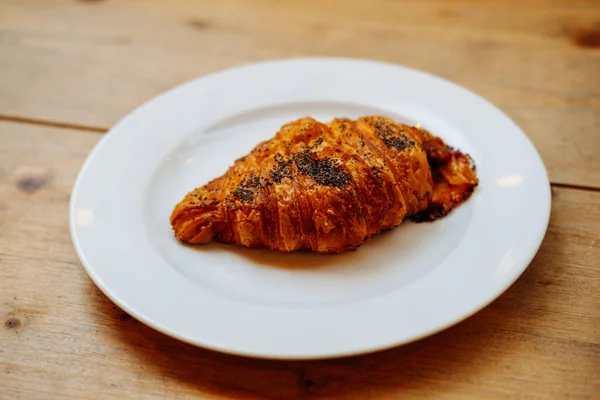 Close Shot Fresh Croissant Poppy Seeds Laying White Plate Wooden — 图库照片