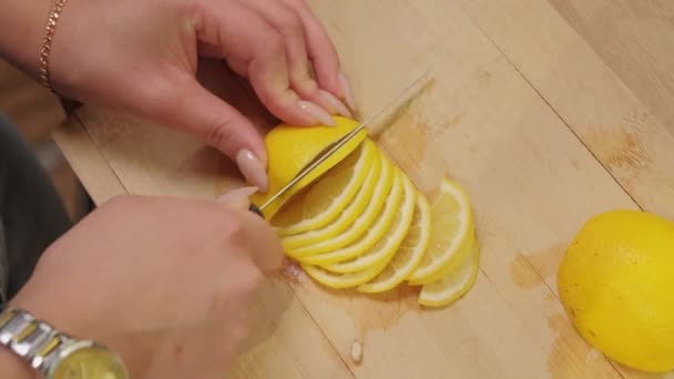 Close Female Hand Slicing Lemon Cutting Board — Stock Video