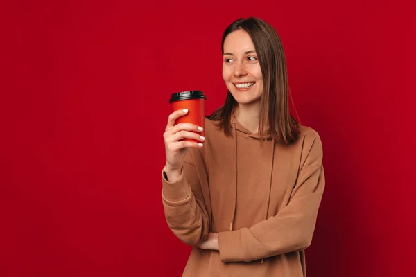 Modern Young Woman Holding Cup While Looking Aside Red Copy — Stock Photo, Image