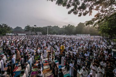 Muslim community carry out the Eid prayer 1444 H on April 21, 2023 at Sempur Field, Bogor, West Java, Indonesia clipart