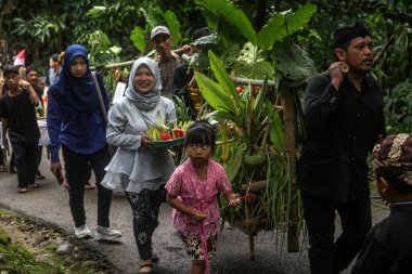 Bogor, Indonesia - July 07, 2024: Residents in Bogor, West Java, celebrate the Sidekah Bumi event by bringing agricultural, plantation and livestock products to share with the community. clipart