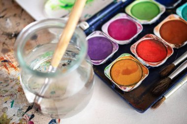 Resim dersleri, boyalı tuvaller, fırçalar ve resim için diğer elementler.