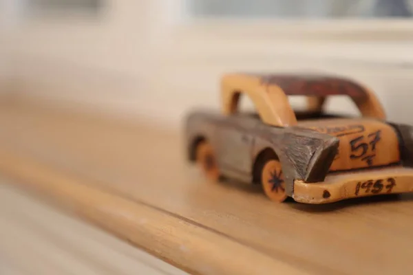 wooden toy car on a background of a wood