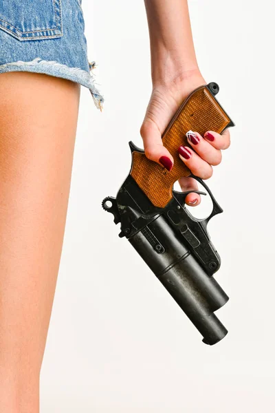 hands of a young woman holding a gun, white background