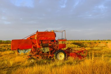 Abandoned tractor or harvester machine in the field