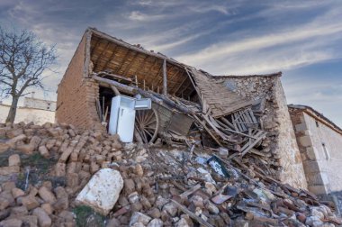 An abandoned house collapses. The house is destroyed